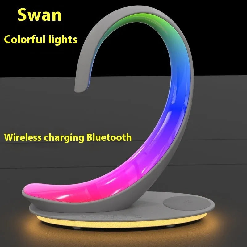 White swan-shaped desktop device with wireless charging, Bluetooth speaker, and colourful mood lighting functions