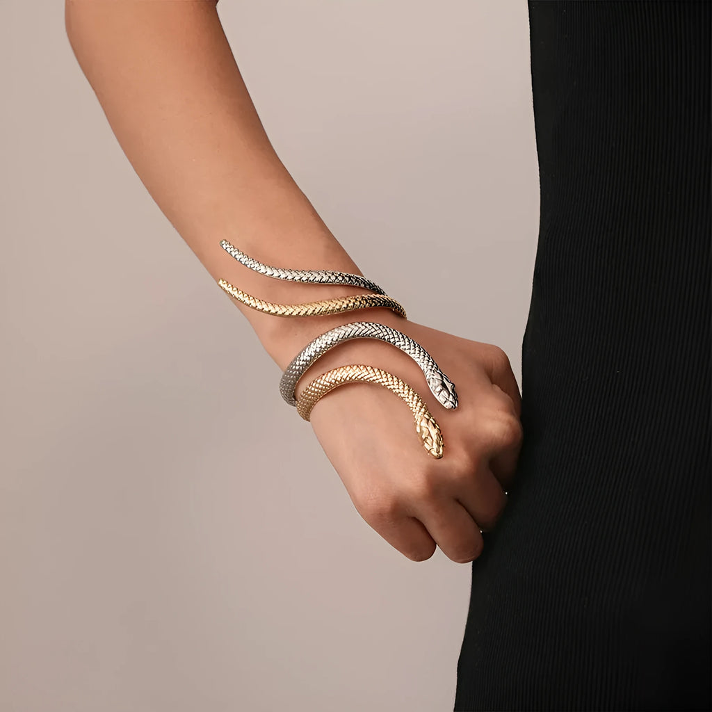 Gold exaggerated twisted winding open snake ring and bracelet jewellery set on white background.