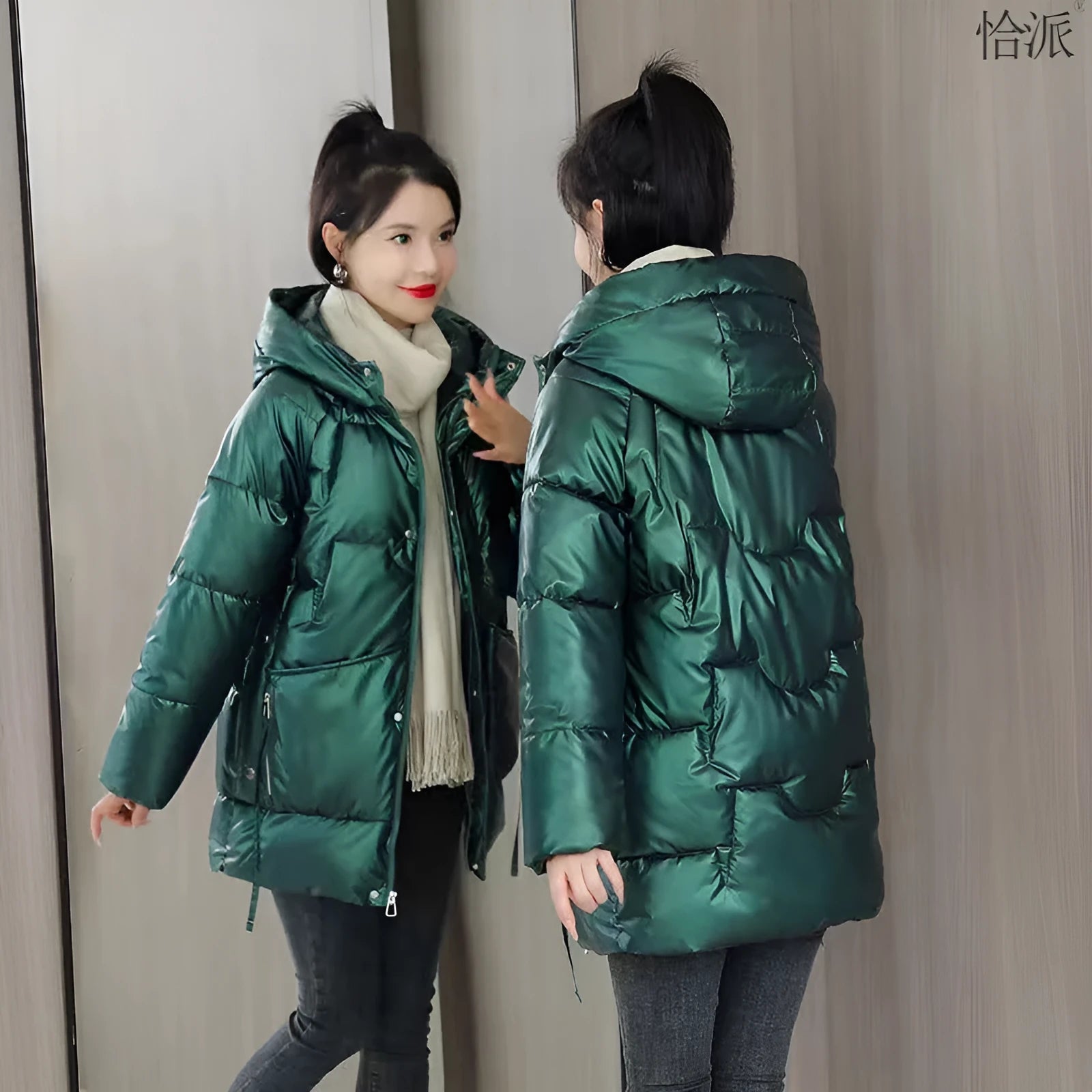 Green loose thick hooded women's winter jacket on a hanger, showing long sleeves and front zip.