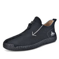 Men's black leather zip-up martin boots with round toe and low heel on a rubber sole.