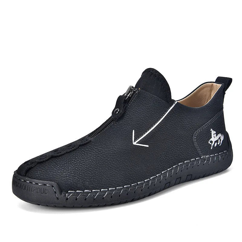 Men's black leather zip-up martin boots with round toe and low heel on a rubber sole.