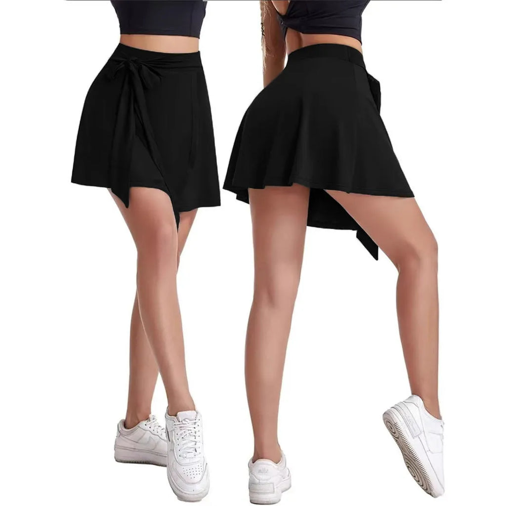 Black thigh-length unisex sports skirt with high waist and integrated shorts.