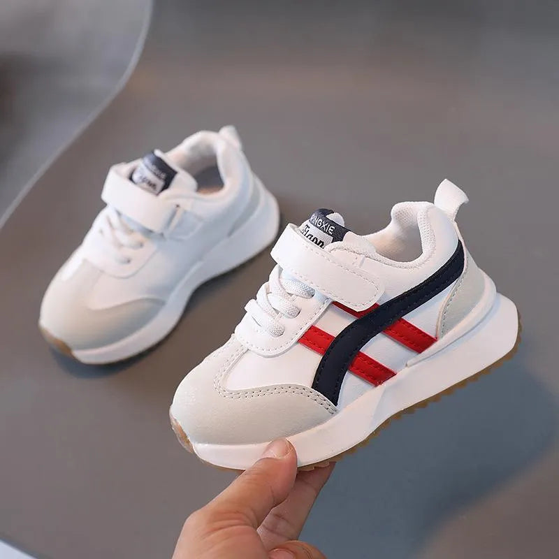 Children's white casual sneaker with Velcro strap, synthetic leather upper, and rubber sole