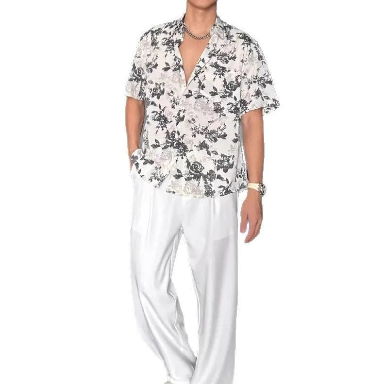 Loose-fitting floral print short sleeve shirt cardigan in black, laid flat.
