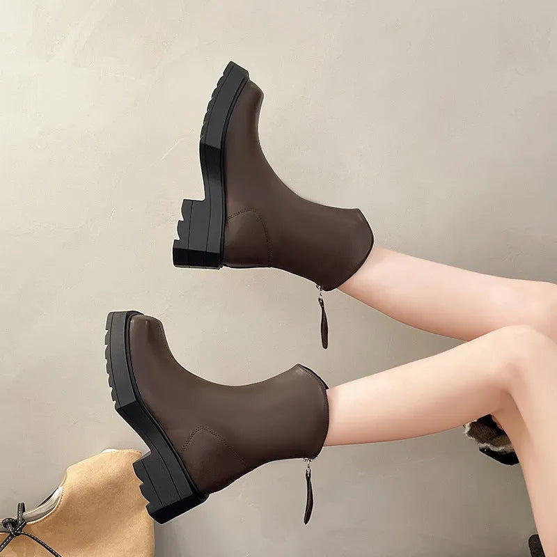 Black platform Martin boots for women with square toe, back zipper, and a high rubber sole.