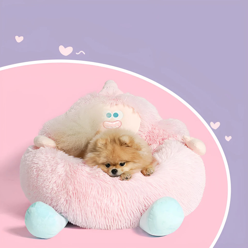 Grey plush round pet nest bed with raised rim for cats and dogs, shown in a home setting.
