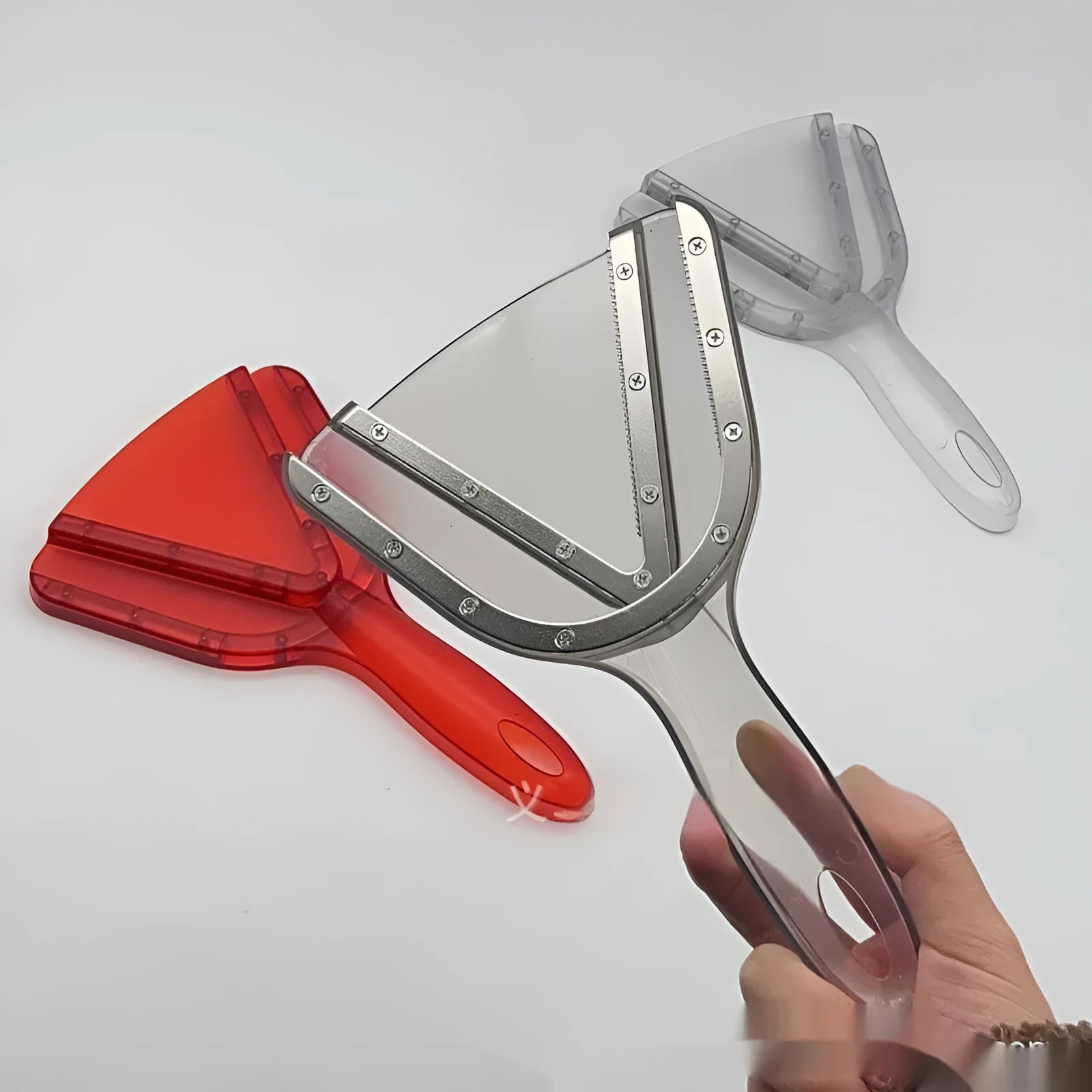 Red plastic telescopic can and bottle opener with non-slip handle on a kitchen counter.