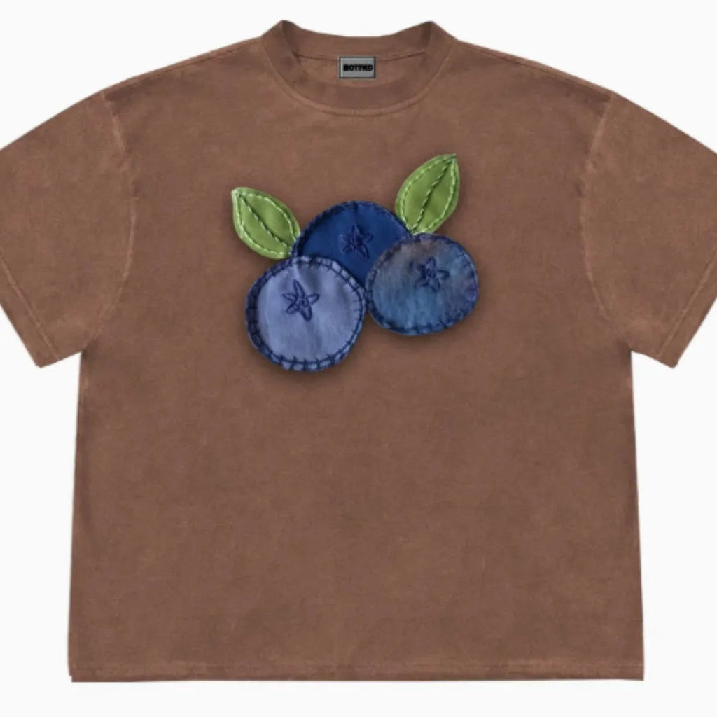 Blueberry and floral patchwork pattern on a loose-fit short sleeve round neck t-shirt.