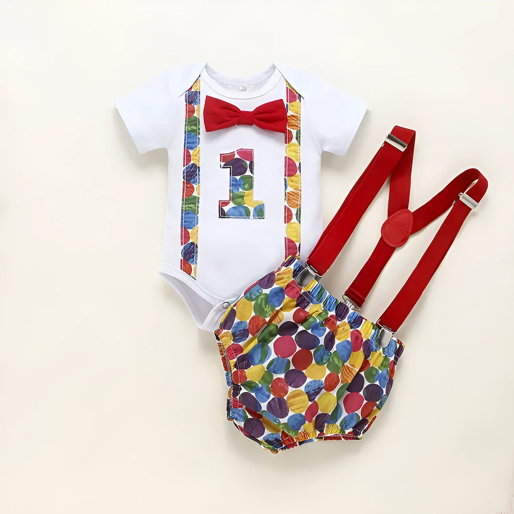 Baby or toddler wearing a soft cotton summer romper overall with shorts, in a choice of dinosaur or polka dot print colours.