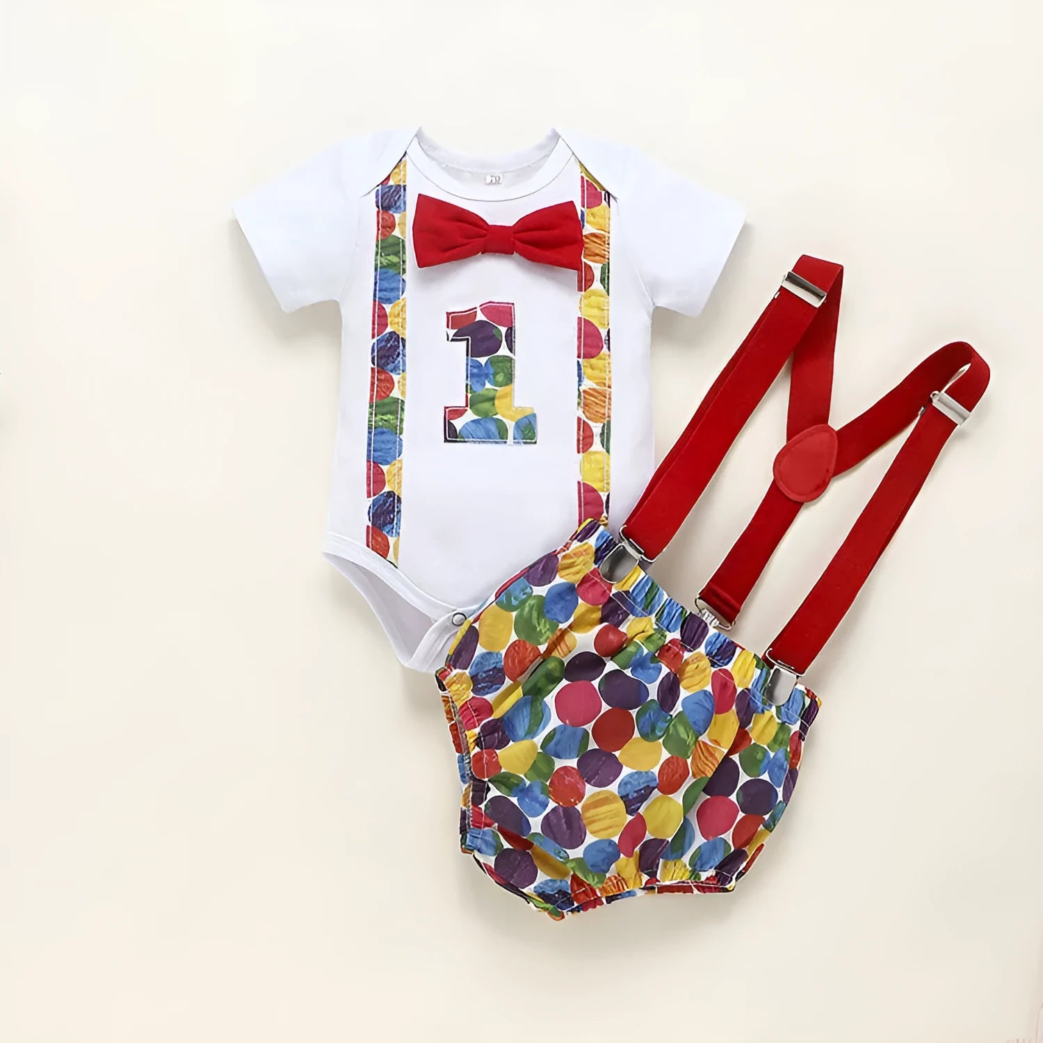 Baby or toddler wearing a soft cotton summer romper overall with shorts, in a choice of dinosaur or polka dot print colours.