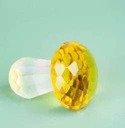 Colourful crystal mushroom decorative ornament in modern geometric style on a plain background.