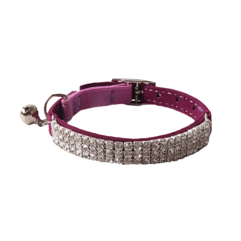 Pink flannel cat collar with elastic buckle and gang drill pattern lying flat.