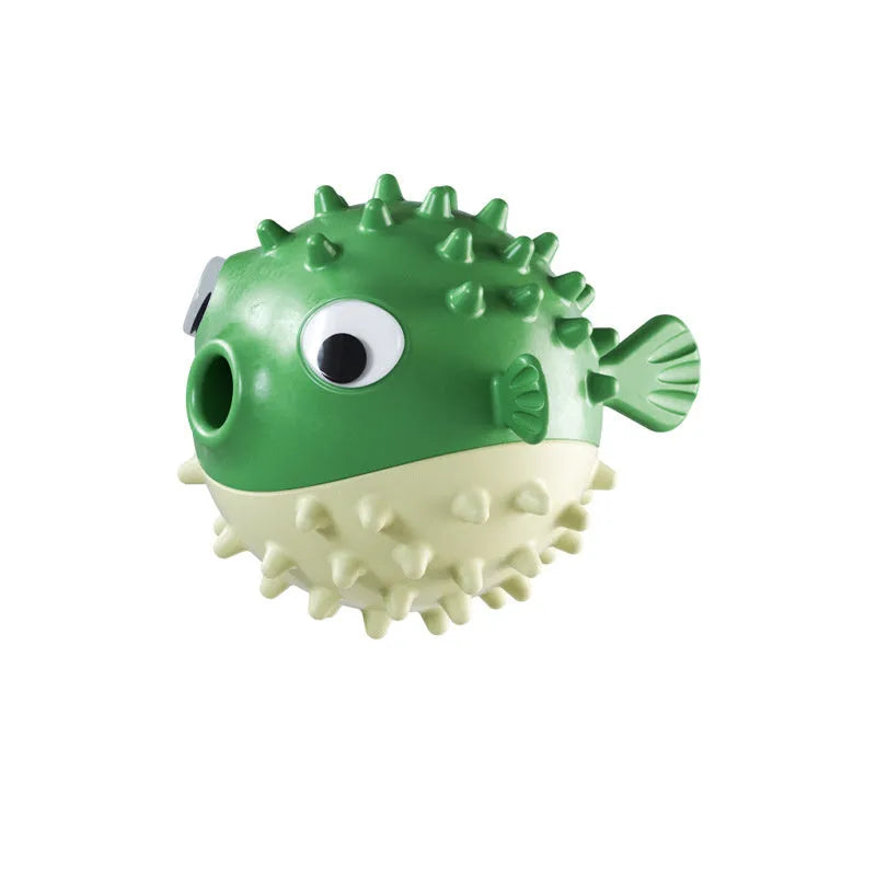 Green fish-shaped interactive dog chew toy with treat-dispensing hole and textured surface.