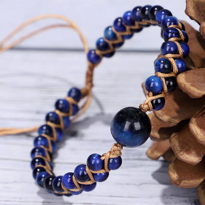 Handwoven geometric bracelet made from blue Tigereye stone beads with a slip-on closure.