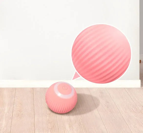 Green automatic rotating ball cat toy with intelligent obstacle avoidance, shown on a hard floor.
