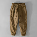 Men's army green cotton overalls with drawstring waist and ankle-band legs on a plain background.