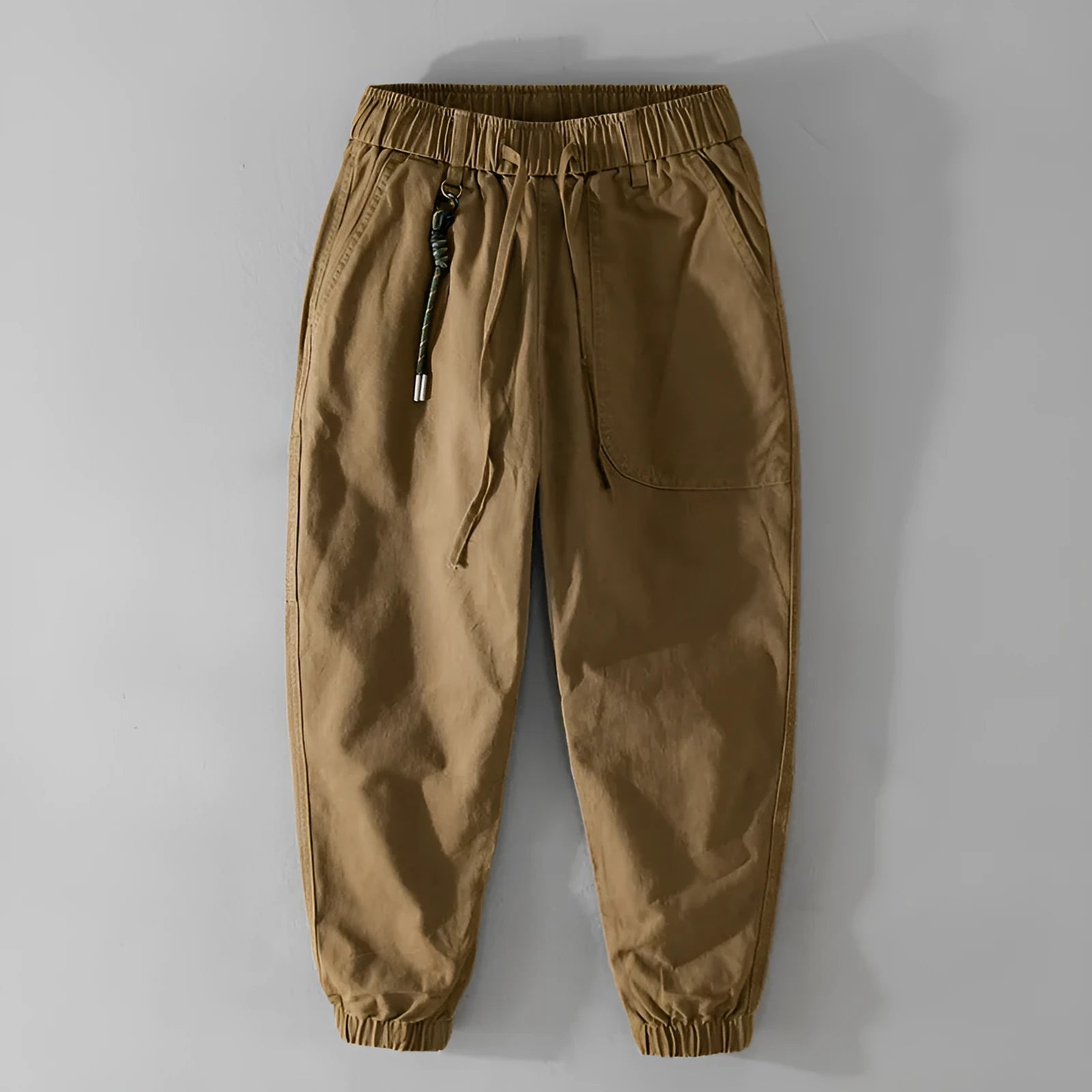 Men's army green cotton overalls with drawstring waist and ankle-band legs on a plain background.