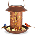 Solar-powered iron bird feeder with hummingbird pattern and built-in LED lamp for outdoor garden use
