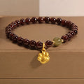 Cat's paw garnet crystal bracelet for women showing clear beads with feline charm