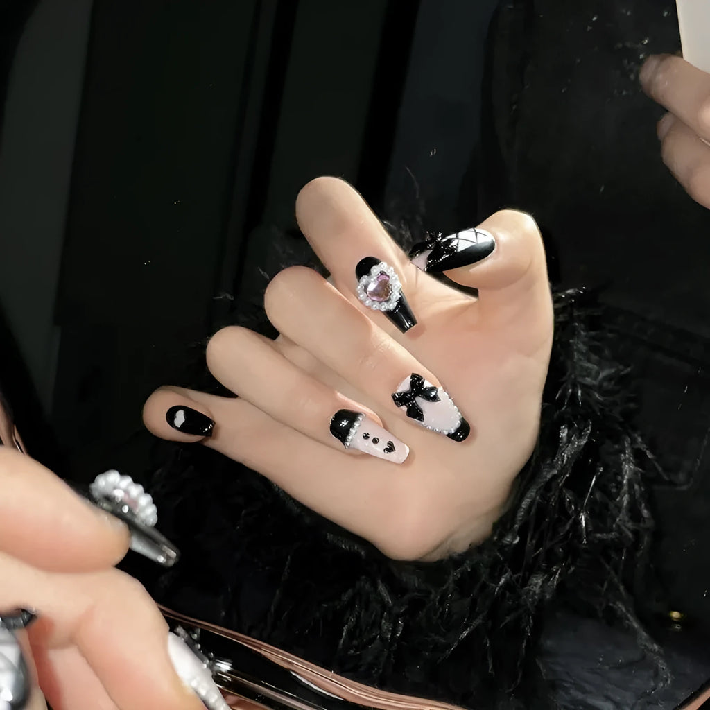 Black and pink heart-shaped hand-painted press-on artificial nails in cat's eye style