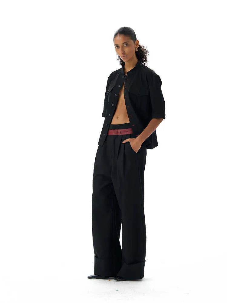 Handmade black half-sleeve shirt with a shirt collar and single-breasted front, shown in a loose fit.