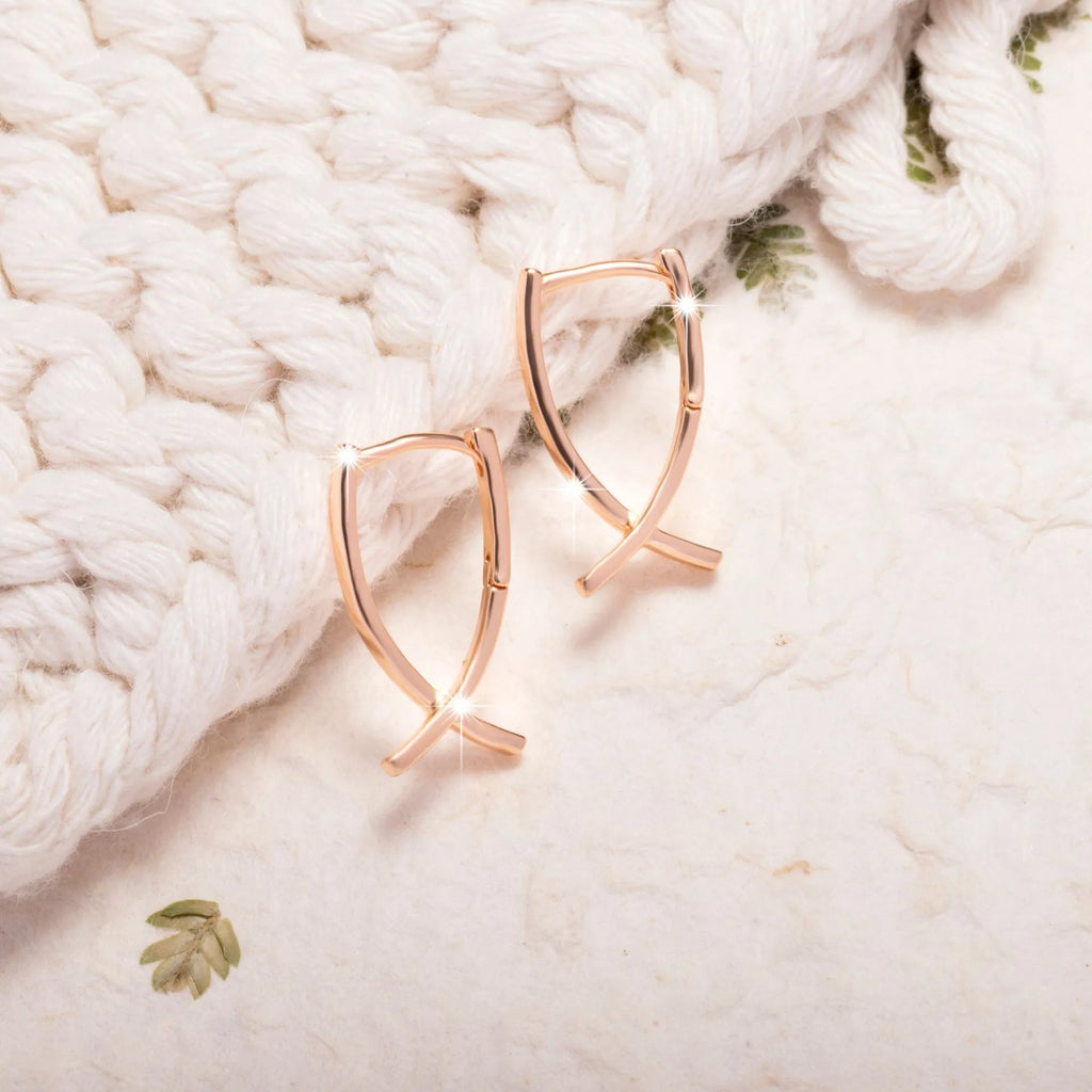 Rose gold cross shaped earrings on a copper base, light luxury style