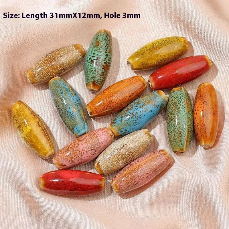 Ceramic bullet beads in various colours for jewellery making and craft projects