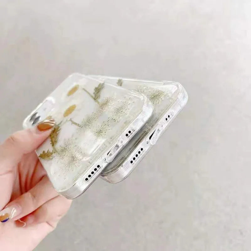 White epoxy daisy floral pattern on a glass back iPhone protective case.