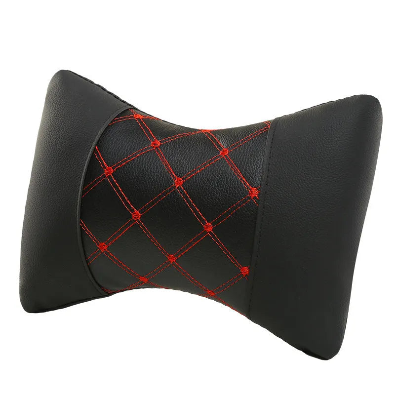 Black quilted leather car headrest pillow with diamond pattern and red stitching for neck support.