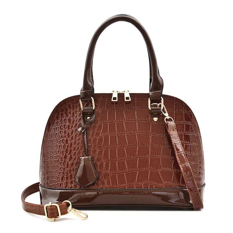 Women's shiny PU leather crossbody shoulder bag showing black, brown, and red colour options with 22x30x15cm dimensions