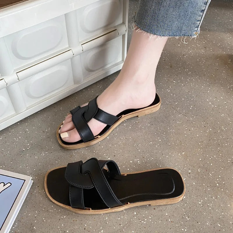 Women's solid-colour cross-strap PVC sandals with a toe-ring design on a non-slip sole.