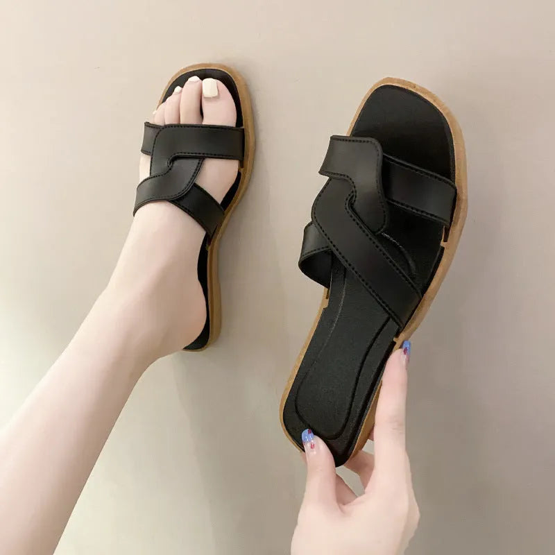 Women's solid-colour cross-strap PVC sandals with a toe-ring design on a non-slip sole.