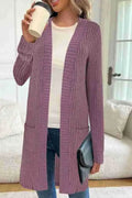 Long sleeve loose knitted cardigan jacket in black, shown with side pockets.