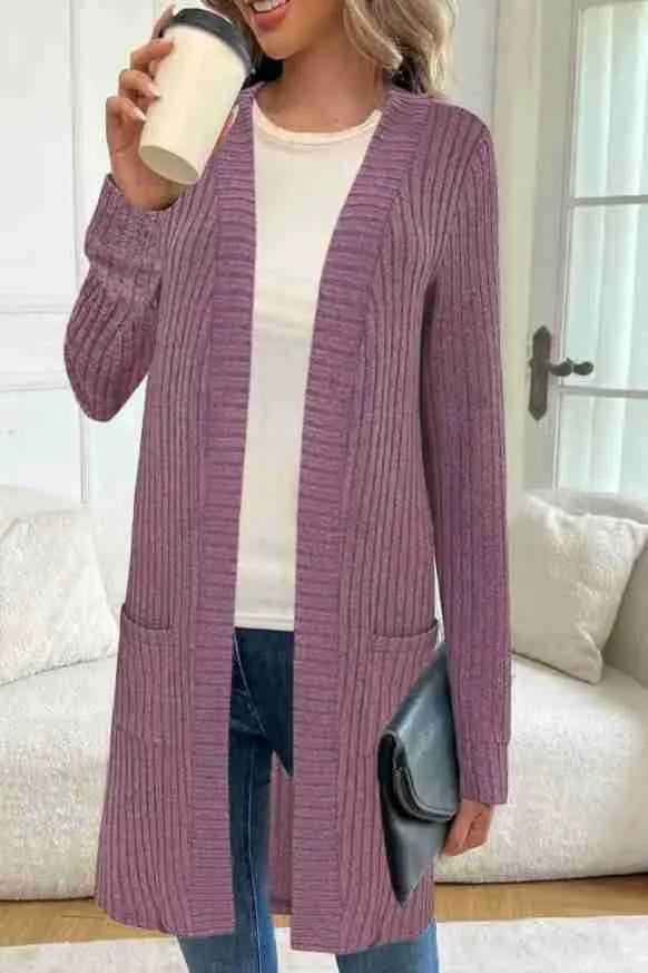 Long sleeve loose knitted cardigan jacket in black, shown with side pockets.
