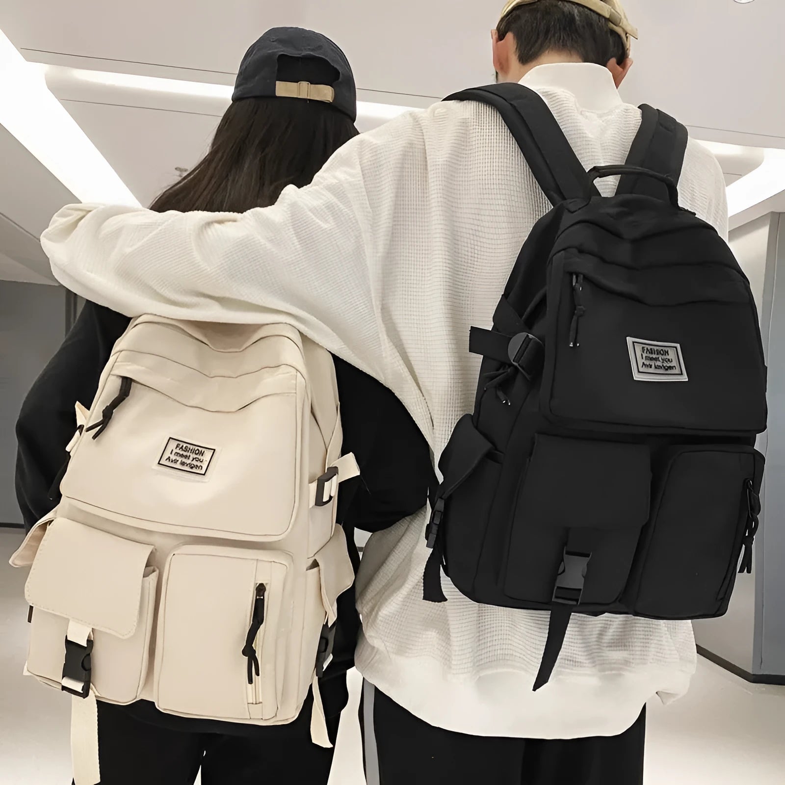 Black and white nylon student backpack with laptop compartment and 3D pockets.