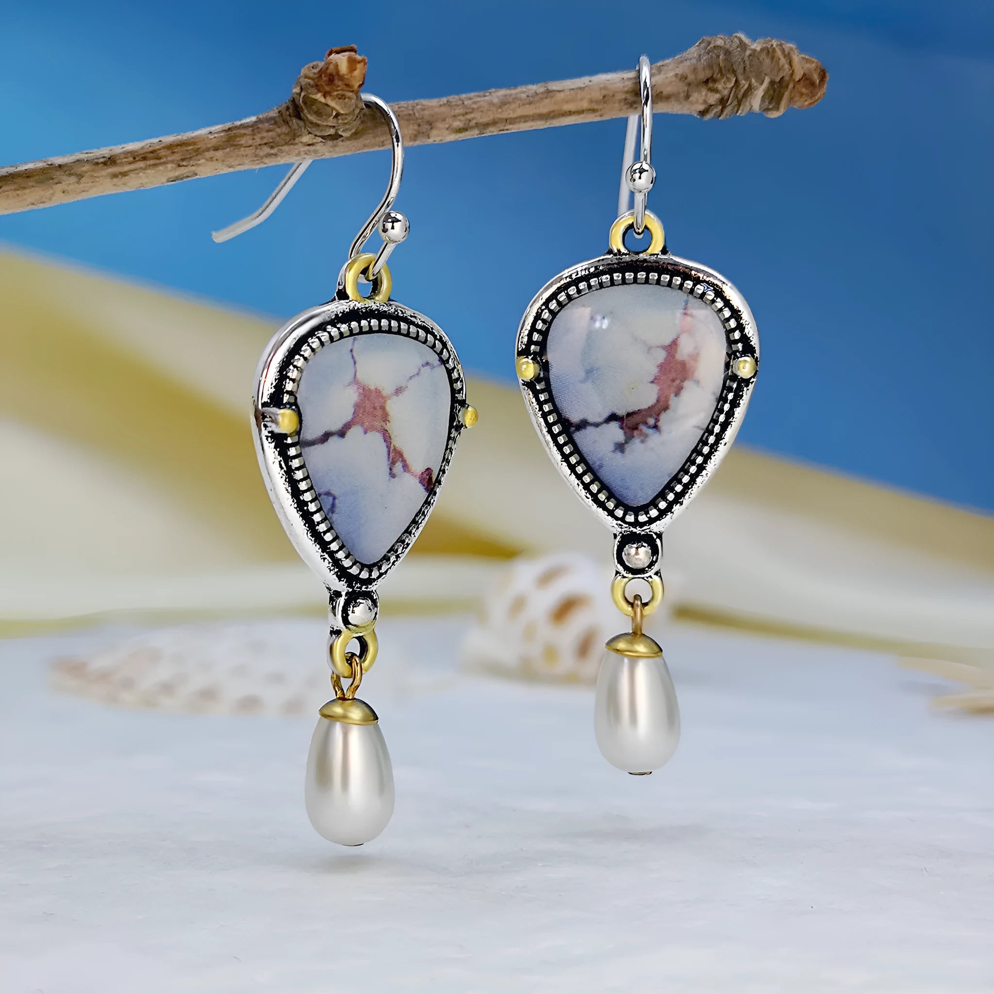 Retro blue drop earrings with electroplated metal, synthetic blue opal, and white pearl components