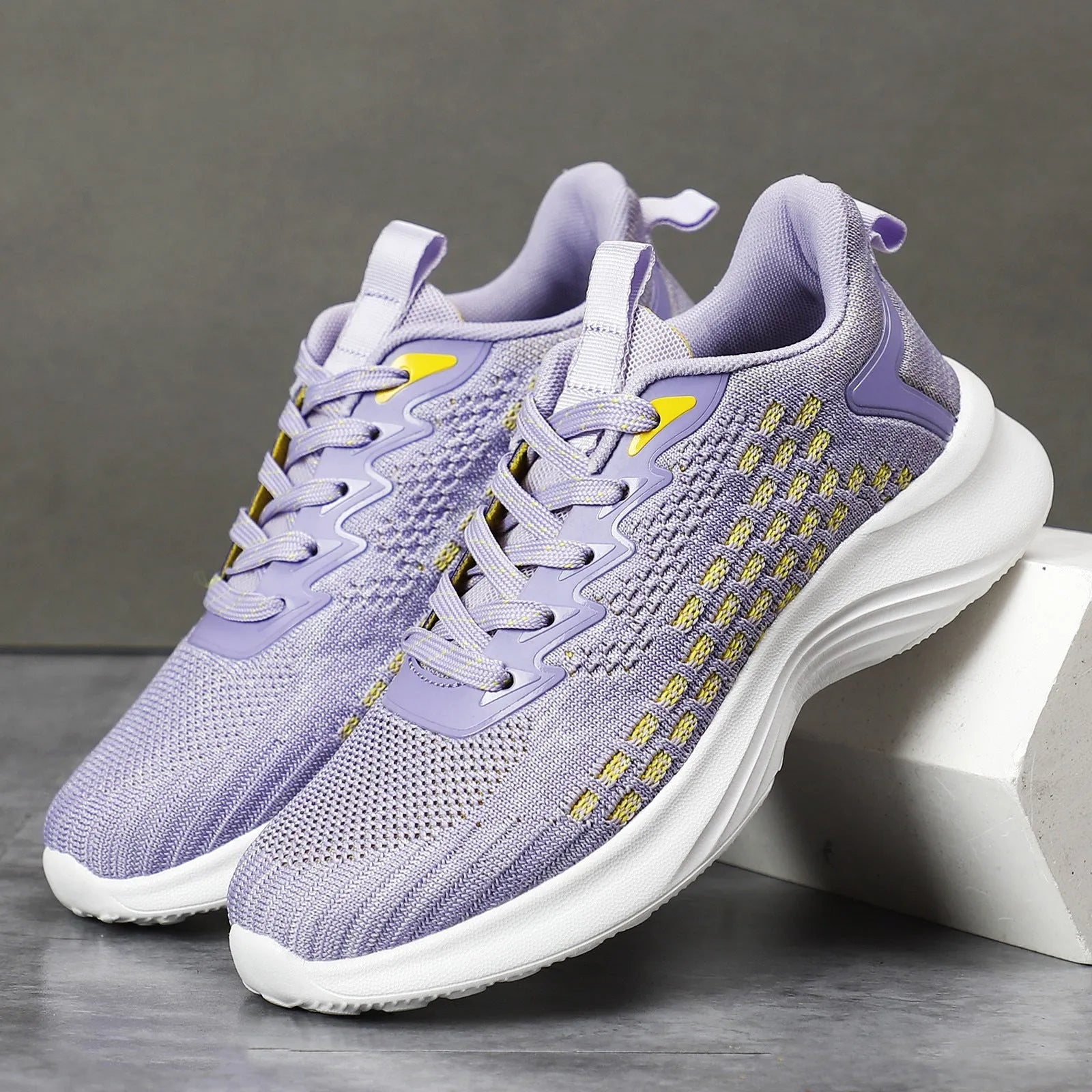 Lavender purple women's Flyknit running shoes with mesh upper and striped pattern on an EVA sole.