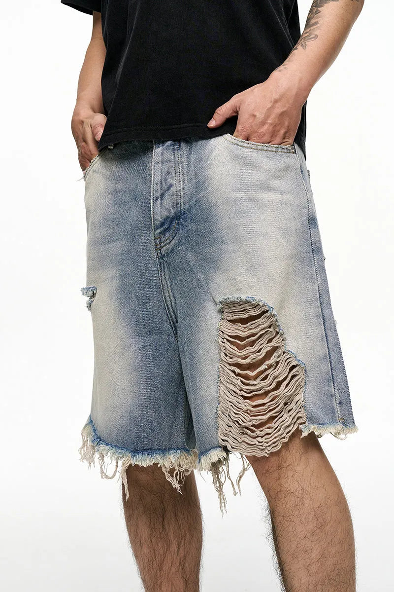 Men's light blue baggy denim shorts with wide leg cut and zip fly