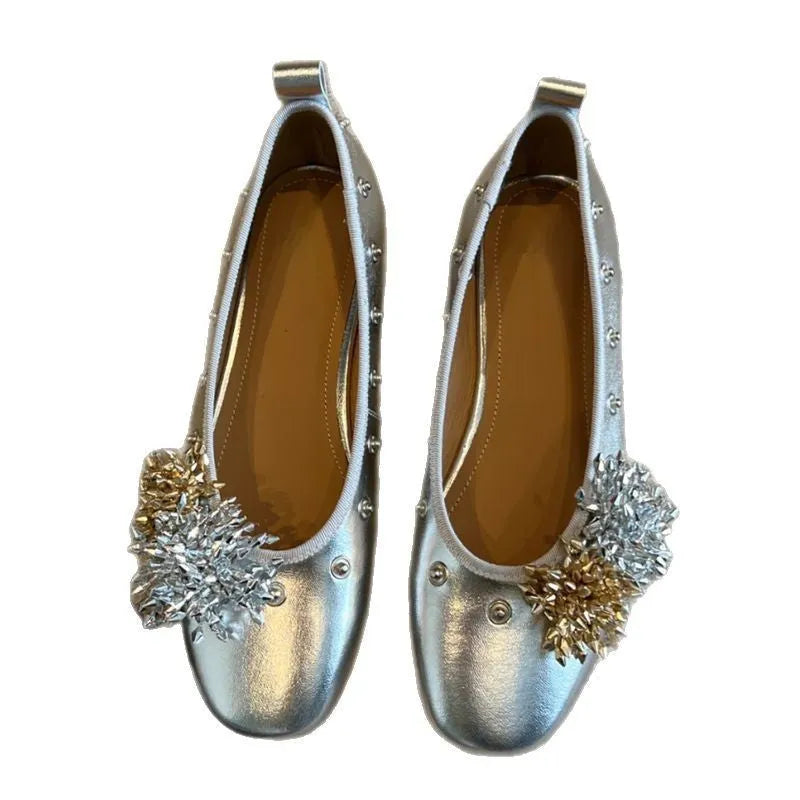 Women's silver Mary Jane flat shoes with a buckle strap and sheepskin upper.