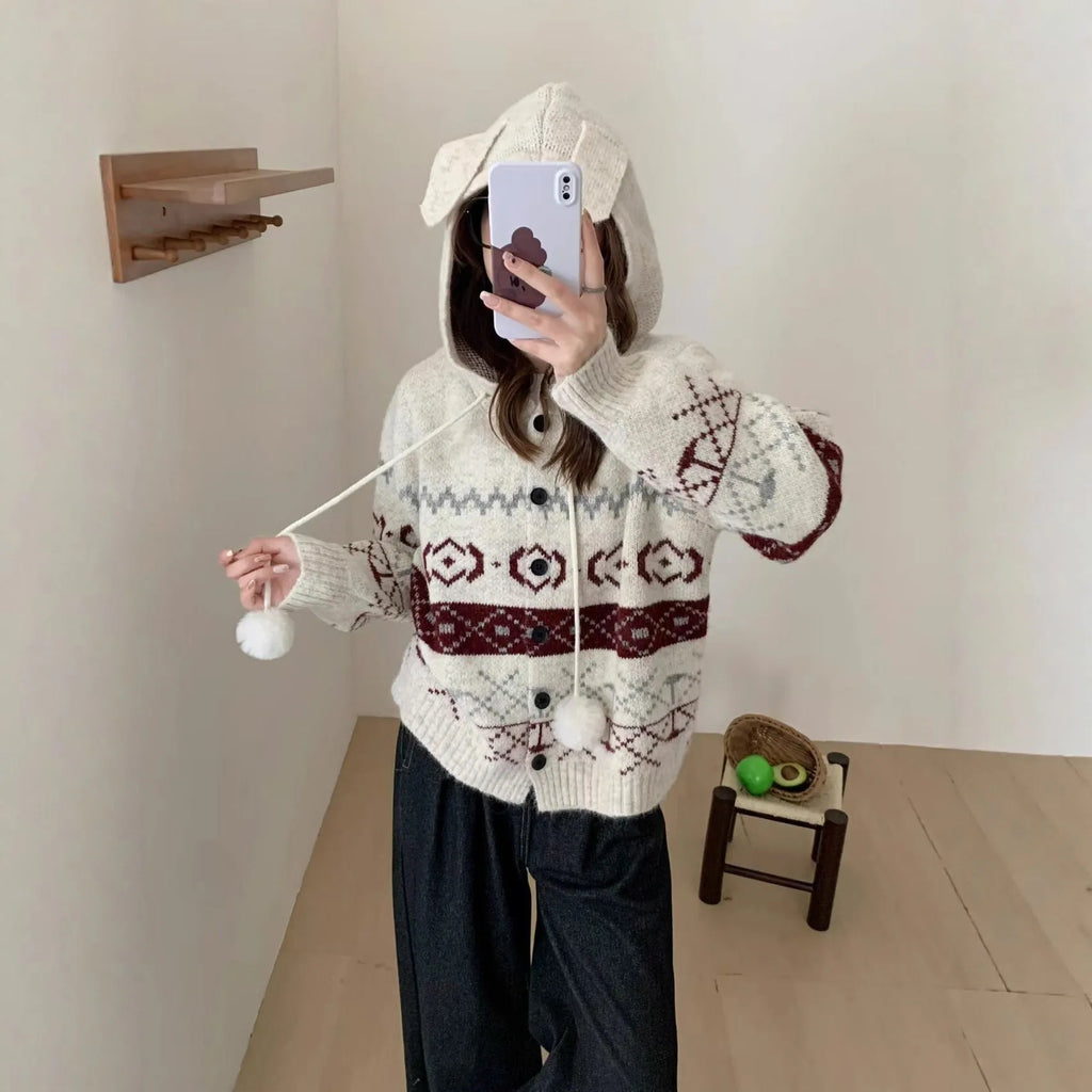 Loose fit grey geometric brocade sweater coat for plus size women on a hanger.