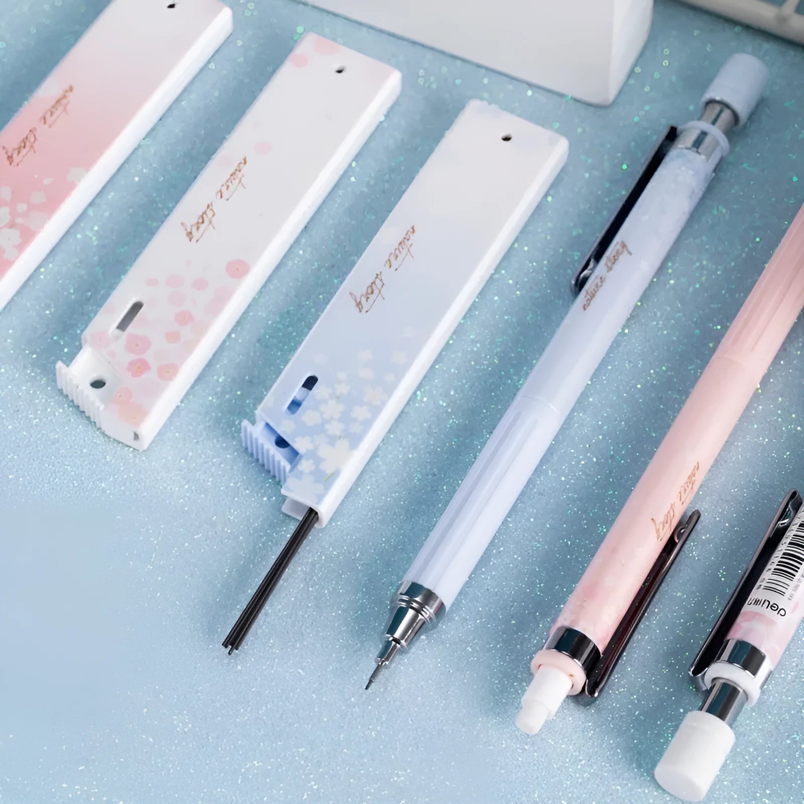 Mixed colour cartoon design automatic pencil set with three pens and boxes of HB refills.