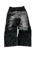 Man wearing loose fit black wide leg cotton casual trousers
