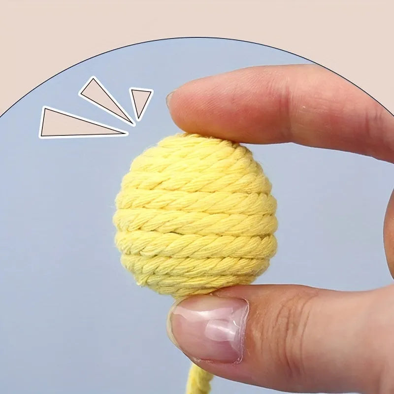 Cat toy ball with rope handle in green, pink, purple or yellow colours with internal bell