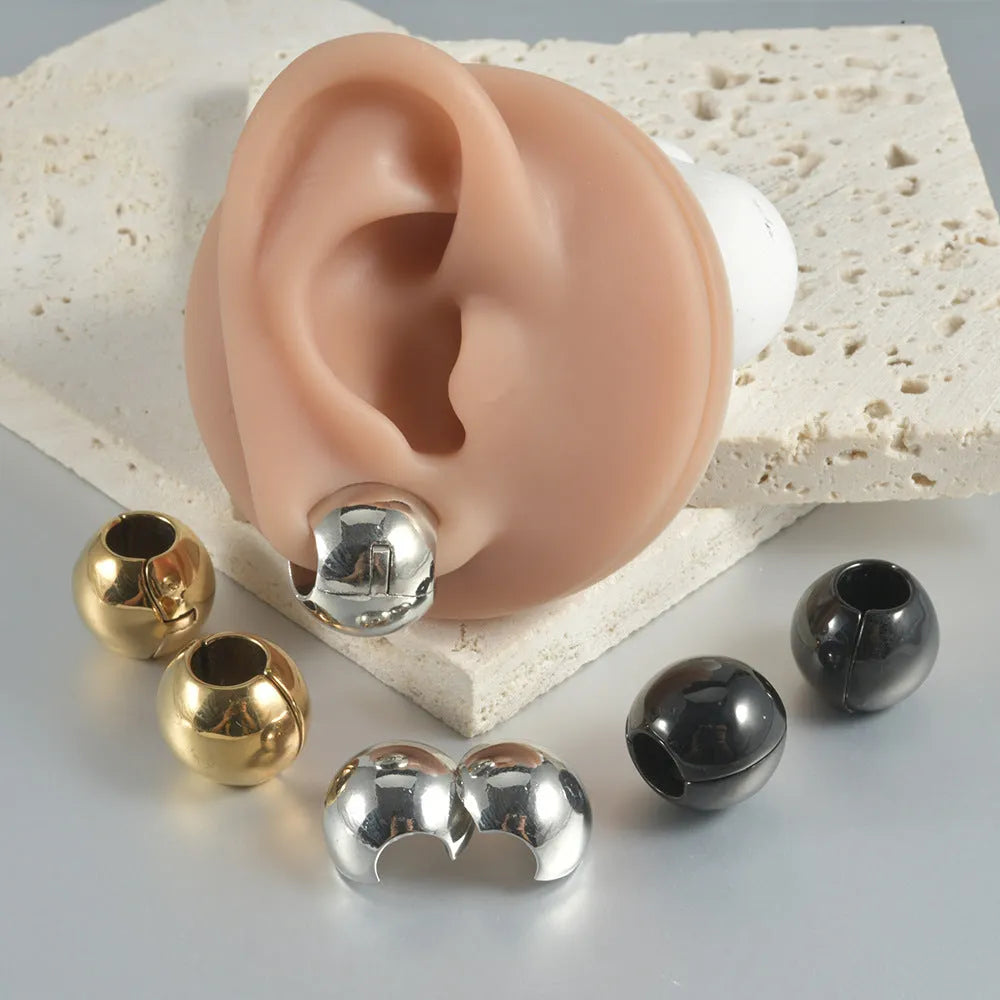 Stainless steel hollow skull and Buddha head earrings in hip hop style.
