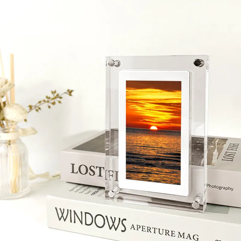White vertical digital photo frame with 5-inch screen showing family photographs