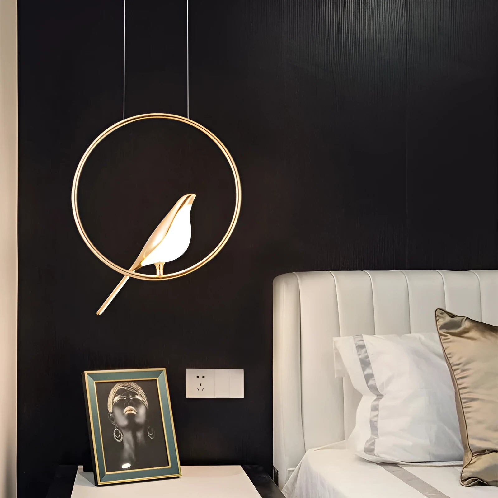 Minimalist clear acrylic magpie bird chandelier ceiling light with a metallic frame.