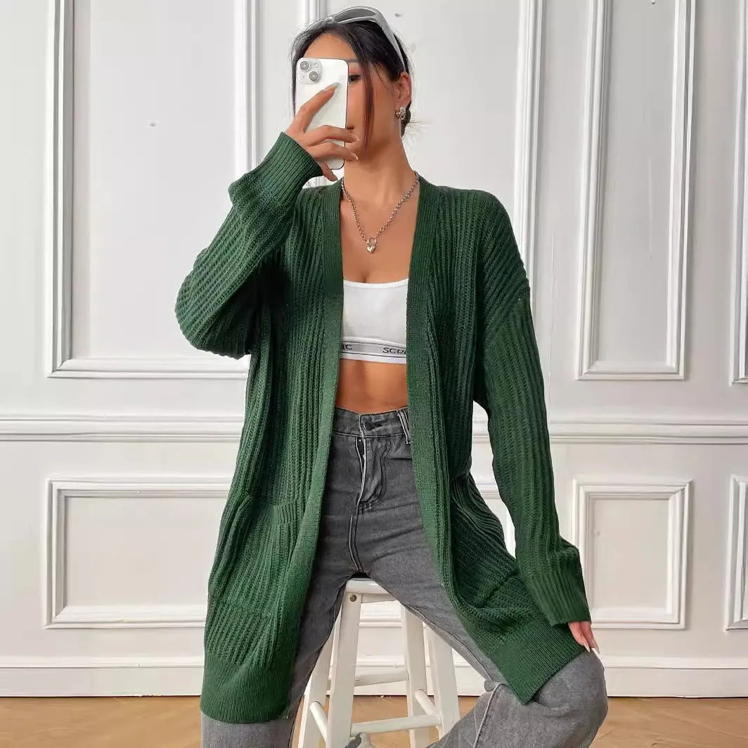 A woman's loose-fit mid-length cardigan in a solid colour, shown on a hanger.
