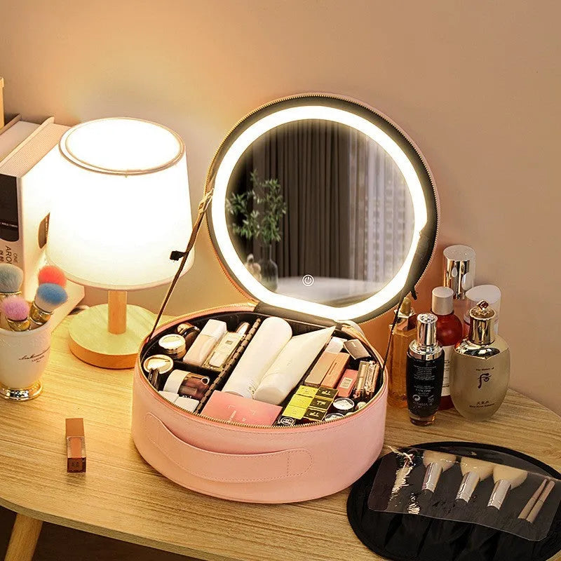 Round pink PU leather makeup bag with LED mirror open, showing internal partitions and carry strap.