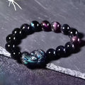 Natural Ice Colour Eye Obsidian crystal bracelet with round beads on an adjustable cord.