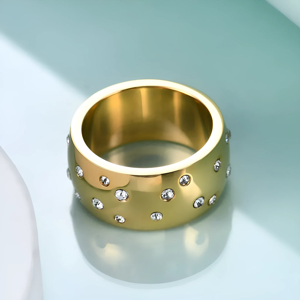 Geometric titanium steel couple ring with diamond treatment in rose gold finish on a size chart.